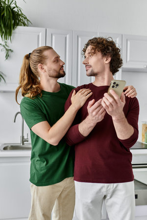 Two affectionate partners enjoy a tender moment while using a smartphone.の写真素材