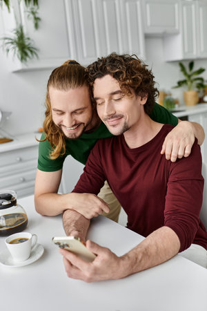 Two partners share a joyful moment while enjoying coffee together.の写真素材