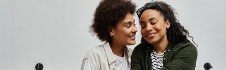 A happy couple shares intimate moments while exploring their hotel room on a joyful getaway.の写真素材