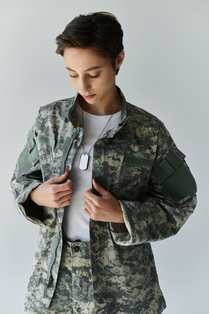 female soldier prepares for military service in a studio setting.