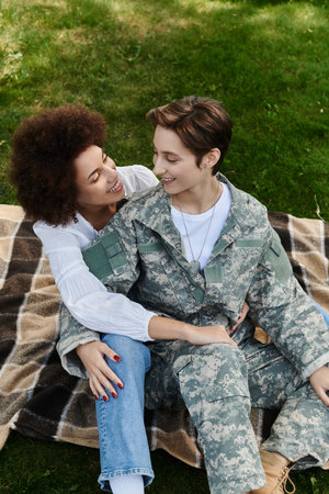 A proud military soldier is welcomed home with love and joy by her wife in a beautiful reunion.の写真素材