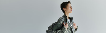 A soldier in camouflage prepares for deployment, banner