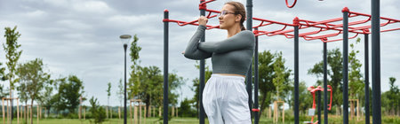 A determined young woman exercising outdoors in fitness park