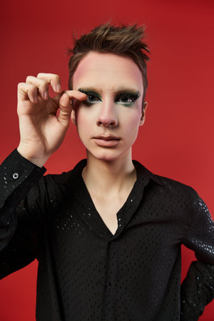 A lively drag artist expresses creativity with striking attire and dynamic pose.の写真素材