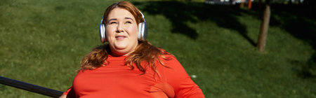 A joyful woman embraces the energy of fitness outdoors.