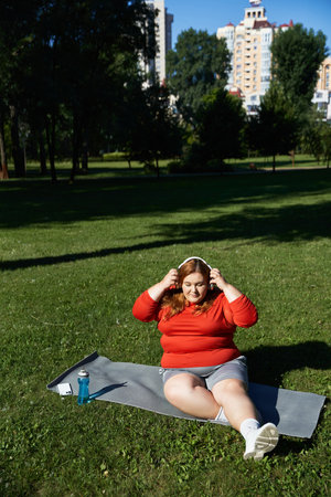 A plus size woman exercises outdoors, embracing nature and fitness.
