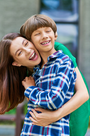 A mother shares laughter and affection with her little hearing impaired son.