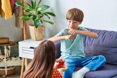 A mother and her son share a moment of playful interaction at home.の写真素材
