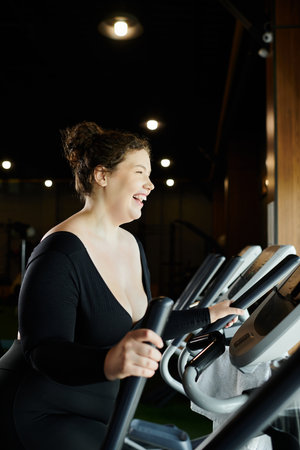 A plus-size woman smiles joyfully while exercising on a stationary bike in an inviting gym.