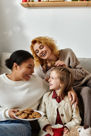 A joyful afternoon with a lesbian couple and their daughter sharing cookies and laughter.