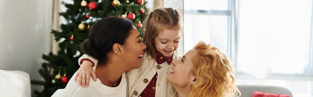 A loving family shares laughter and warmth together at home during the festive season.の写真素材