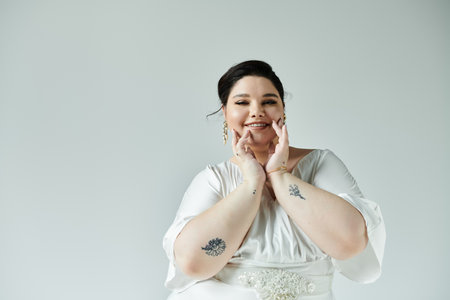 A beautiful plus size bride beams with joy, showcasing her elegant white dress and delicate earrings.の写真素材
