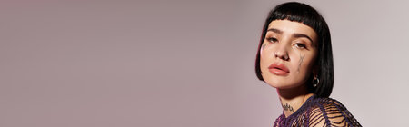 A fashionable young woman showcases her unique tattoos with a striking expression.