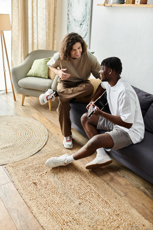 Two partners create beautiful memories at home, sharing music and laughter in a cozy setting.