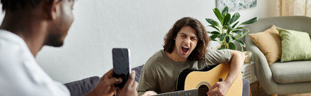 A joyful couple shares a musical moment while relaxing at home in their living space.の写真素材