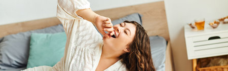 A young woman with beautiful features stretches joyfully in her warm, inviting bedroom.