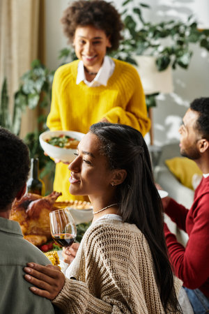 A group of friends enjoying a hearty Thanksgiving meal, filled with laughter and warmth.の写真素材