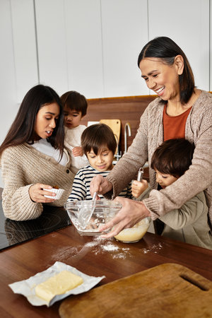A happy Asian family enjoys baking together in a cozy kitchen ahead of Christmas, creating lasting memories.の写真素材