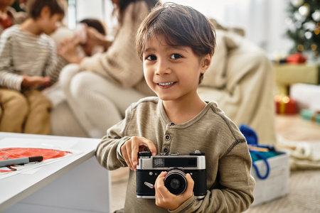 A joyful family gathers near a Christmas tree, celebrating the holiday spirit with love and laughter.の写真素材