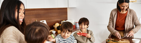 An Asian family happily prepares delicious holiday treats in their modern kitchen with cheerful kids.の写真素材
