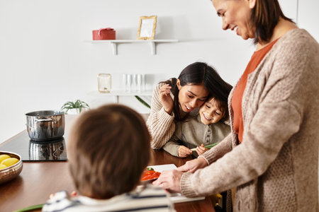 A joyful family enjoys cooking holiday treats in their bright, modern kitchen, full of laughter and love.の写真素材