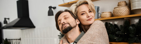 A couple shares a warm embrace in their cozy kitchen, radiating love and happiness.