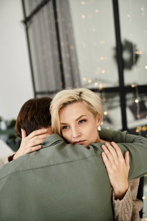 A couple embraces warmly in a serene living space, radiating love and connection.の写真素材