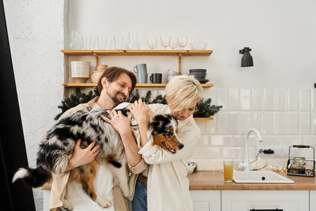 A joyful couple embraces their dog while spending quality time together at home.の写真素材