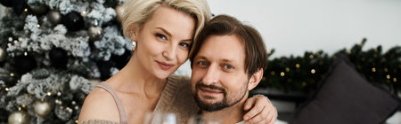 A joyful couple enjoys their time together, surrounded by elegant holiday decorations.の写真素材