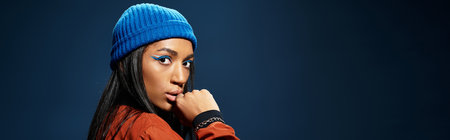 The young woman confidently poses in a warm autumn outfit, highlighting her unique style.の写真素材