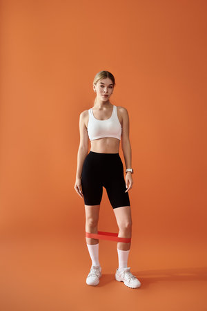 A sportswoman showcases her emotional strength while posing in fitness gear.
