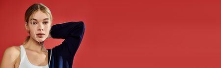 An athletic woman expresses emotion with confidence against a bold red background.