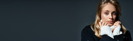 A young beautiful woman gazes thoughtfully, her hands near her face, expressing depth and emotion.の写真素材