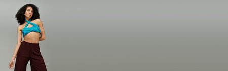 A stunning woman displays her unique fashion sense in a bright, summer outfit, exuding confidence.の写真素材