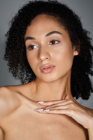 Elegant woman showcases her stylish attire while confidently displaying her natural beauty.