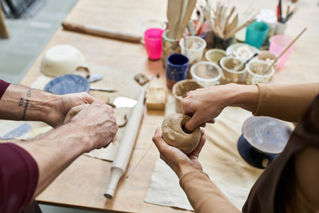 A couple shares creativity and joy while making pottery.