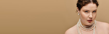 A graceful plus size woman shines in pearls, radiating elegance in a warm setting.の写真素材