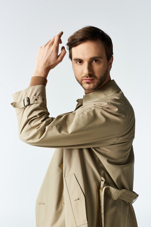 A fashionable man confidently showcases his attire, striking a pose that captures attention.の写真素材