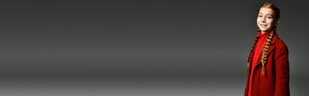 A cheerful girl wearing warm winter clothing enjoys the moment with a beaming smile.の写真素材