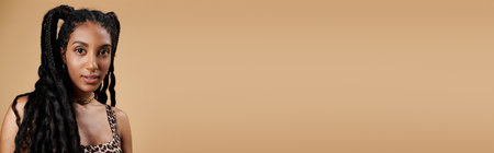 A young woman showcases her fashionable leopard print outfit, combining elegance with playful flair.の写真素材