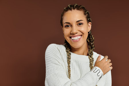 The young woman radiates joy, showcasing her autumn style with a bright smile and playful aura.