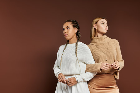 A young, beautiful couple showcases their autumn attire while expressing love and warmth.