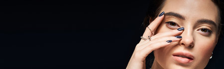 A stunning woman showcases her beauty with an expressive pose and a thoughtful expression.の写真素材