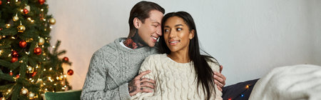 A loving couple shares a special moment at home during the festive Christmas season.