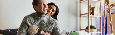A couple shares a tender moment at home during Christmas, radiating love and joy.の写真素材