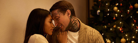 A couple embraces tenderly in a festive setting, surrounded by holiday lights and decorations.
