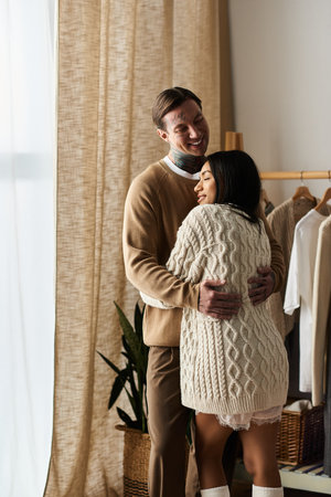 A joyful couple shares a loving moment in their cozy home.の写真素材