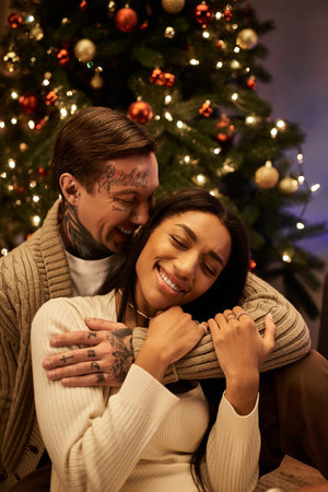 A couple shares laughter and warmth while celebrating Christmas in their beautifully decorated home.の写真素材