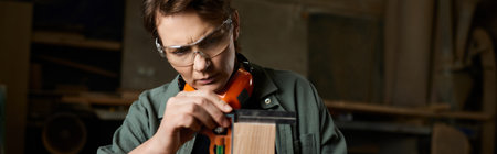 A skilled carpenter focuses on perfecting her woodworking project, showcasing craftsmanship and...