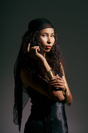 A beautiful woman poses gracefully, showcasing her unique fashion and striking features.の写真素材